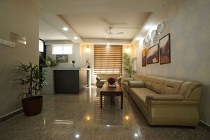 Una sala de estar moderna con un sofá, una mesa de centro y un mostrador de recepción.