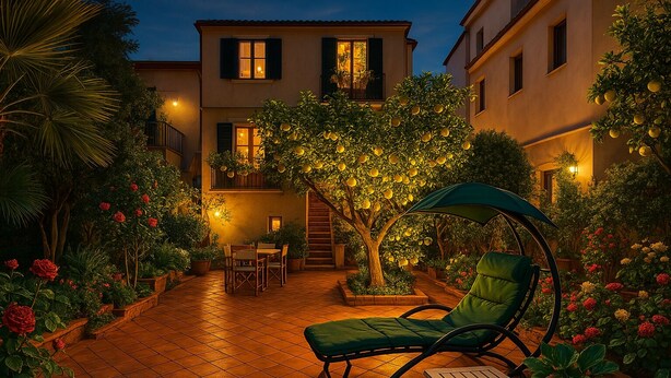 Une terrasse avec une table et des chaises pour les repas, un fauteuil suspendu et une petite table d’appoint.