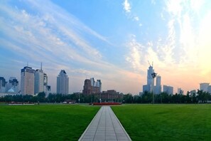 A city skyline with modern buildings and a clear sky. - City Boutique Hotel(Dalian Railway Station People Saunare Subway Branch (Dalian)