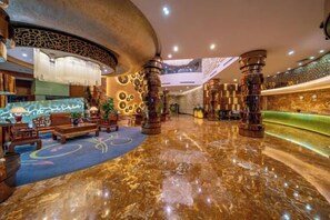 A lobby with a marble floor, a reception desk, and a seating area with a patterned carpet. - Xixiangfeng International Hotel (Pingxiang Railway Station) (Pingxiang)