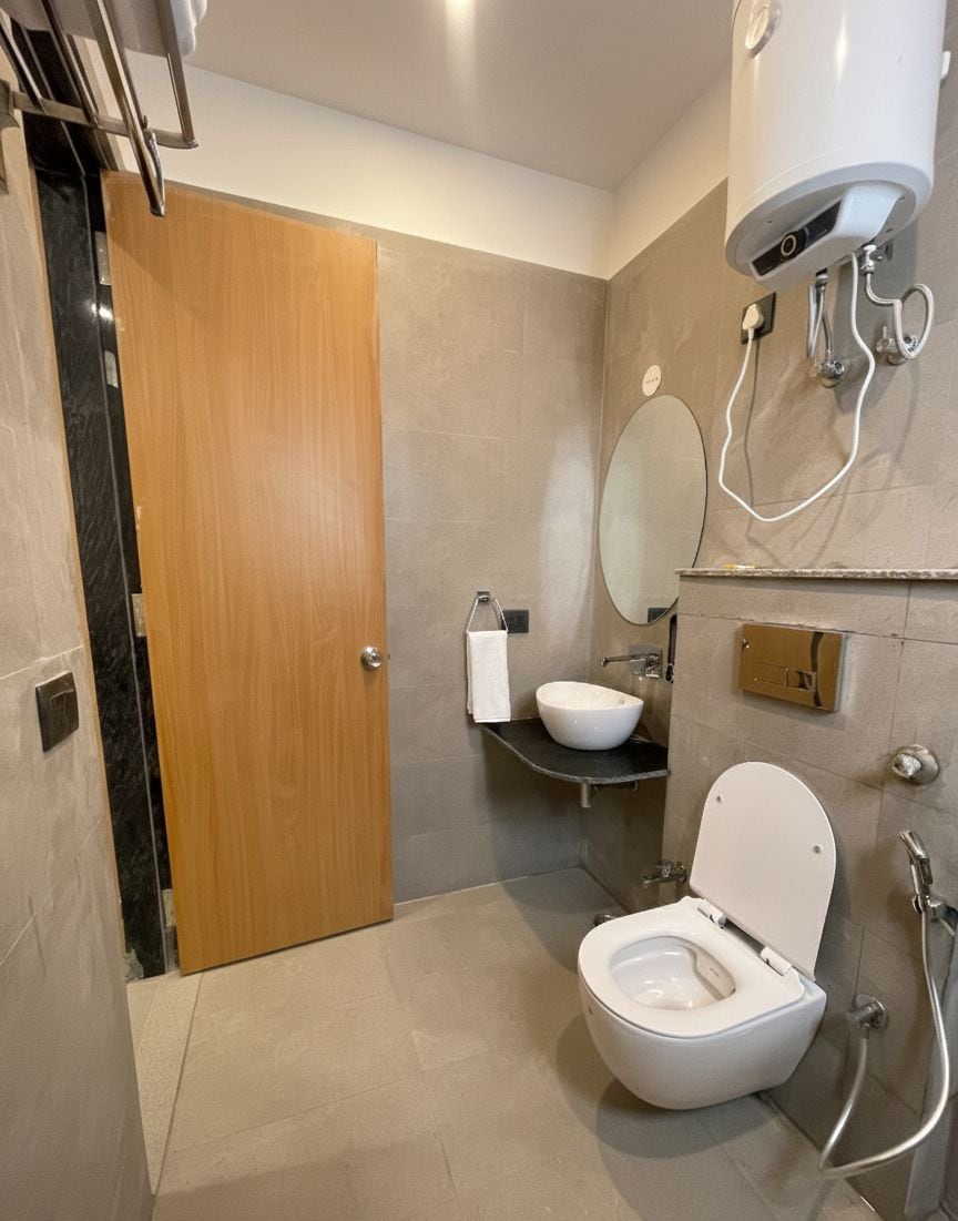 A modern bathroom with a toilet, sink, and shower.