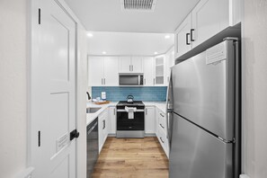 Fridge, stovetop, dishwasher, coffee/tea maker