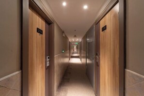 A hotel hallway with doors numbered 222 and 223, leading to rooms. - Pebble Motel (Shanghai Jinqiao Metro YanggaoRoad) (Shanghai)