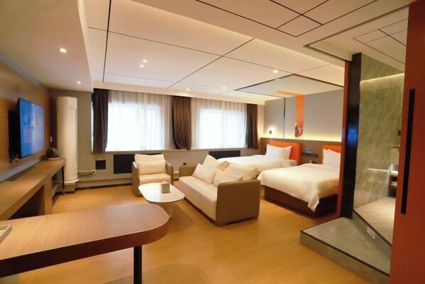 A hotel room with a sofa, two beds, a TV, and a desk. - Peoples Hotel (Lanzhou)
