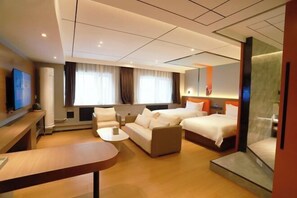Relax in this stylish room with a large bed, two additional beds, and a sofa set, perfect for families or groups.