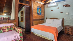 A room with a bed, a bench, a window, a door, and a wall-mounted air conditioner.