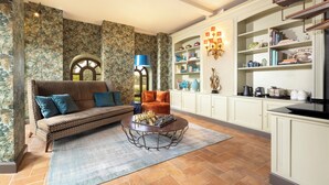 A living room with a sofa, a coffee table, and a bookshelf.