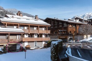 A ski resort building with multiple balconies, a cinema, and a restaurant.