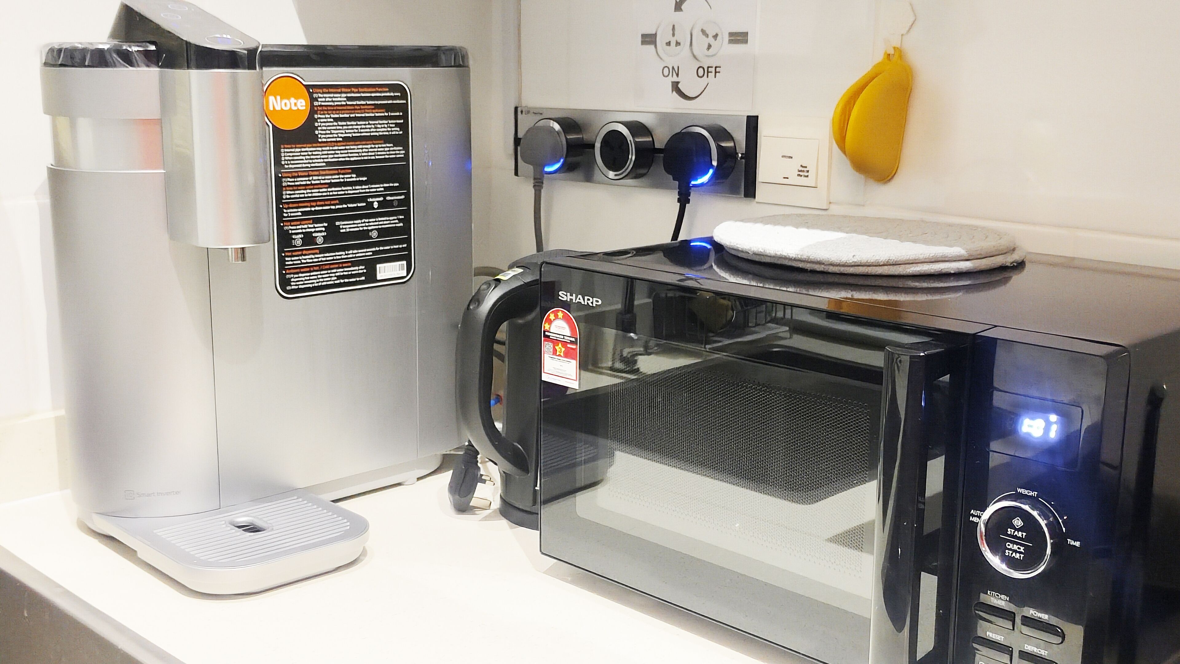 A kitchen with a coffee maker, a microwave, and a toaster.