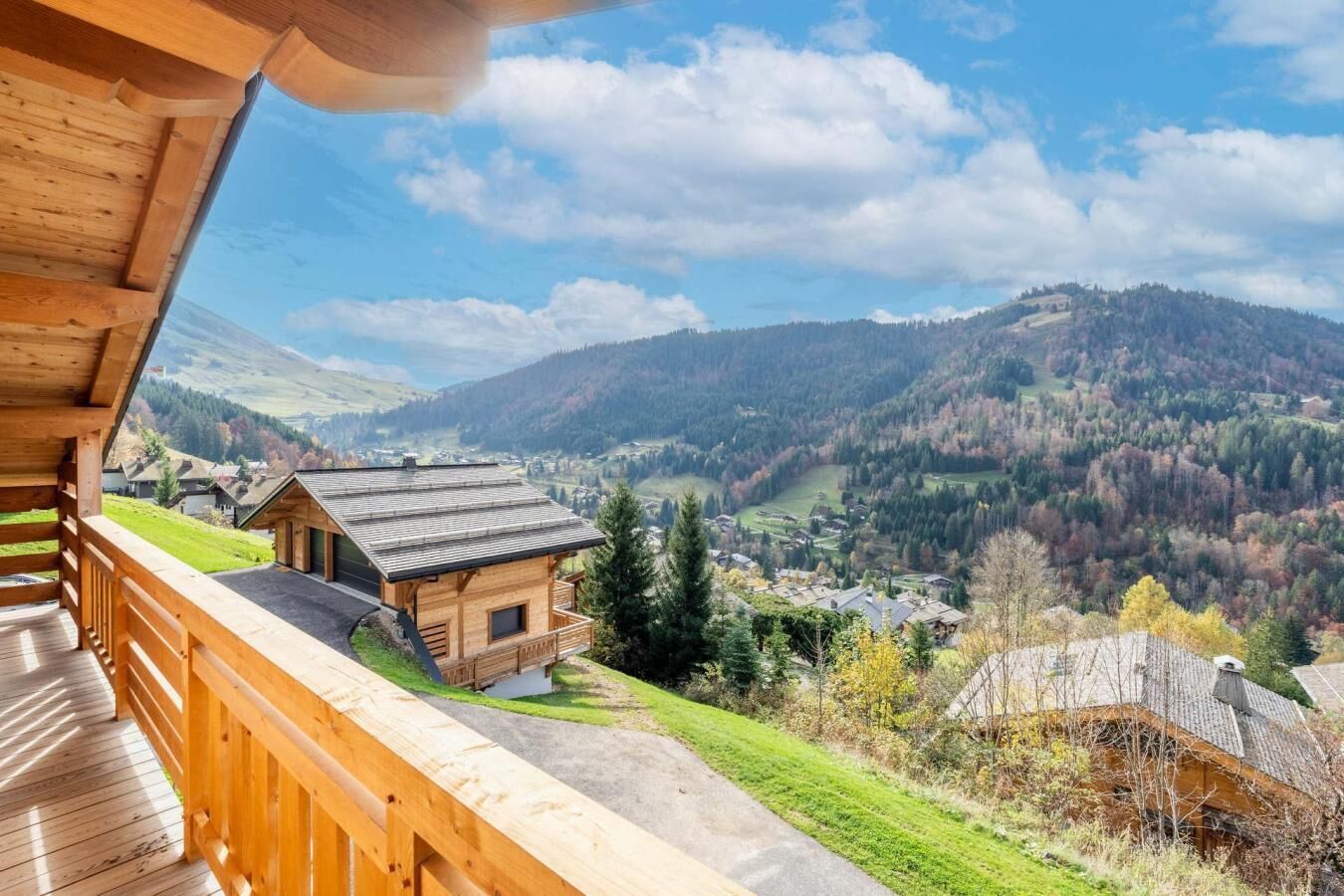 Una baita di legno con un balcone affacciato su un paesaggio montuoso.