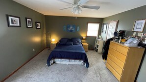 A bedroom with a bed, dresser, nightstands, and a ceiling fan. - Charming cul-de-sac 5BR 3.5BA in State College, PA (Port Matilda)