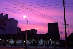 A building with a signboard, a streetlight, and power lines against a sunset sky. - Beihai Hai Yi Hurried That year Inn (Second inn) (Beihai)