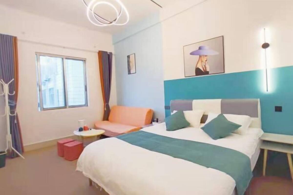 Relax in a spacious room with a large bed, seating area, and a small table for work or relaxation.