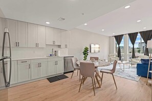 Enjoy a stylish living space with a kitchen, dining area, and comfortable seating.