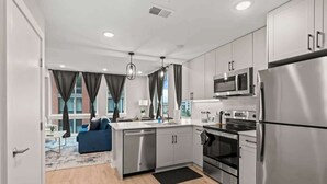A modern kitchen with stainless steel appliances, a dishwasher, and a microwave. - Luxury 1BD | 2 Beds | Northern Liberties (Philadelphia)