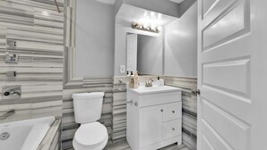 Ein Badezimmer mit Toilette, Waschbecken und Spiegel.
