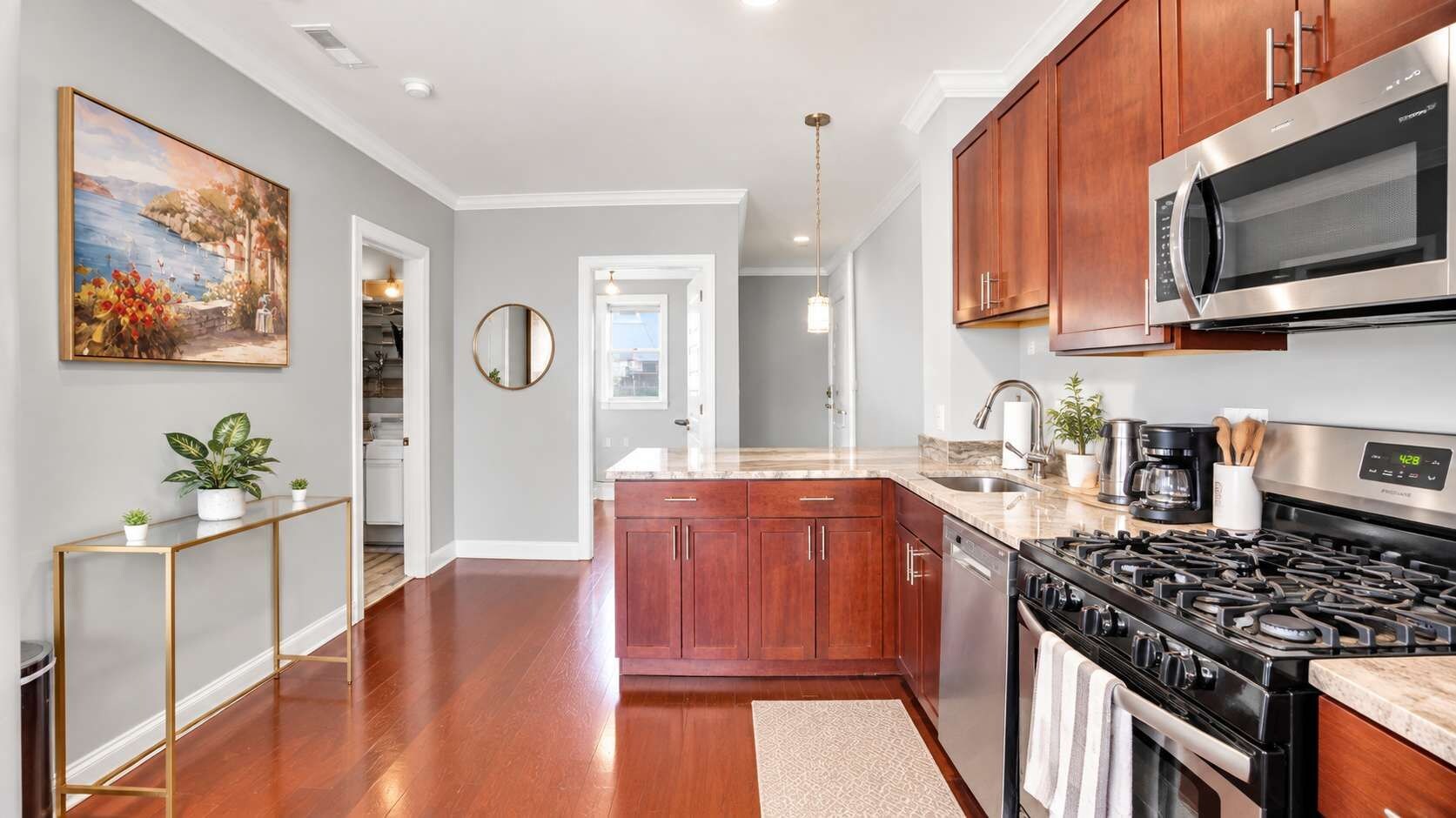 A kitchen with wooden cabinets, a stainless steel stove, and a microwave.