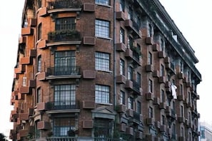 A multi-story building with a brick facade, numerous windows, and balconies. - Longchen Holiday Inn (Shanghai Ruijin Hospital Yongjia Road Branch) (Shanghai)