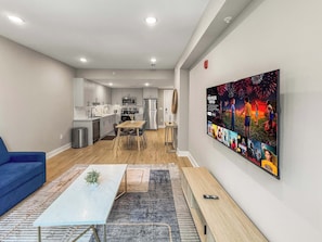 A modern apartment with a kitchen, dining area, and living room.