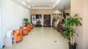 A hotel lobby with a reception desk, seating area, and potted plants. - Qingxu Jinrui 99 Boutique Hotel (Qingxu)