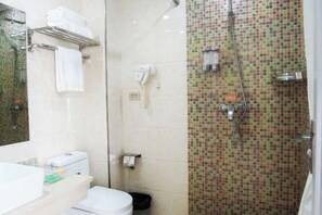 A bathroom with a shower, a toilet, a sink, and a mirror. - Qingxu Jinrui 99 Boutique Hotel (Qingxu)