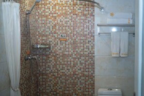 A bathroom with mosaic tile walls, a shower, a toilet, and a towel rack. - Qingxu Jinrui 99 Boutique Hotel (Qingxu)