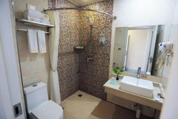 A bathroom with a shower, toilet, sink, and a mirror. - Qingxu Jinrui 99 Boutique Hotel (Qingxu)