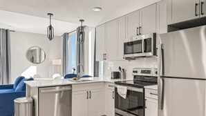 A modern kitchen with stainless steel appliances, a dishwasher, and a built-in oven. - Luxury 1BD | 2 Beds | Northern Liberties (Philadelphia)