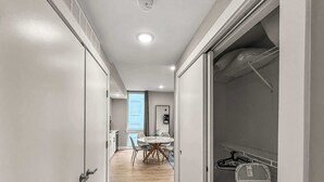 A hallway with a dining area, a coat rack, and a view of the outside. - Luxury 1BD | 2 Beds | Northern Liberties (Philadelphia)