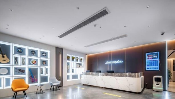 A modern reception area with a marble counter, a neon sign, and a display screen. - Homeinn Ripple Yun Hotel (Guangde Bus Passenger Transport Center) (Guangde)