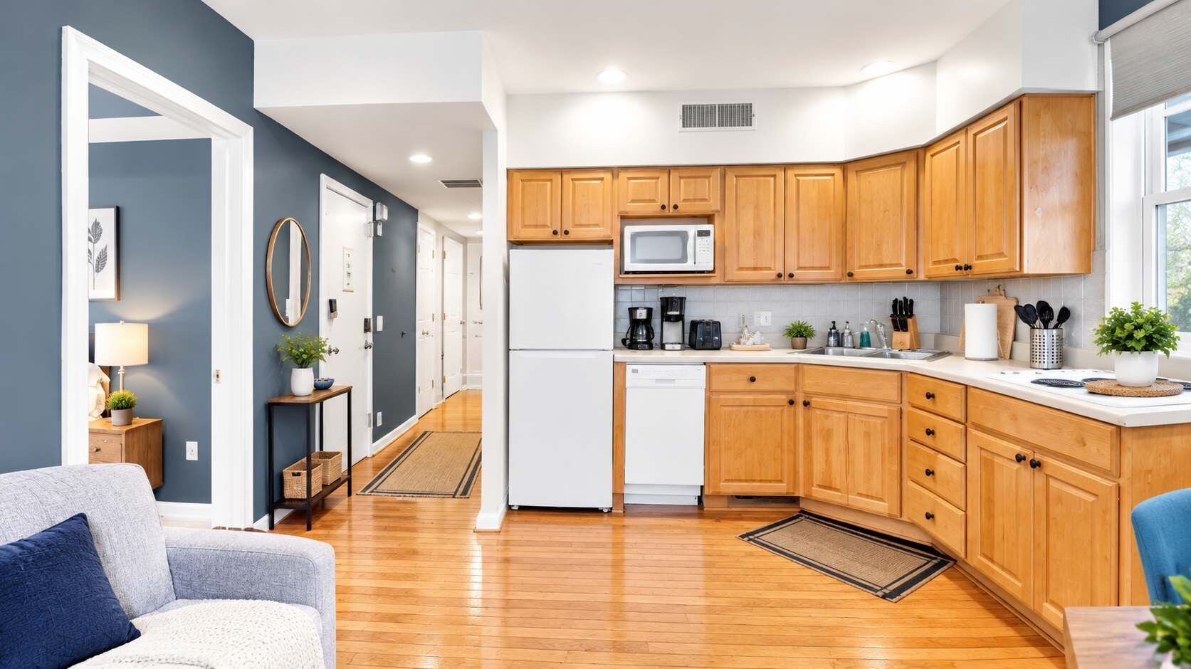 A modern kitchen with wooden cabinets, a microwave, and a dishwasher.