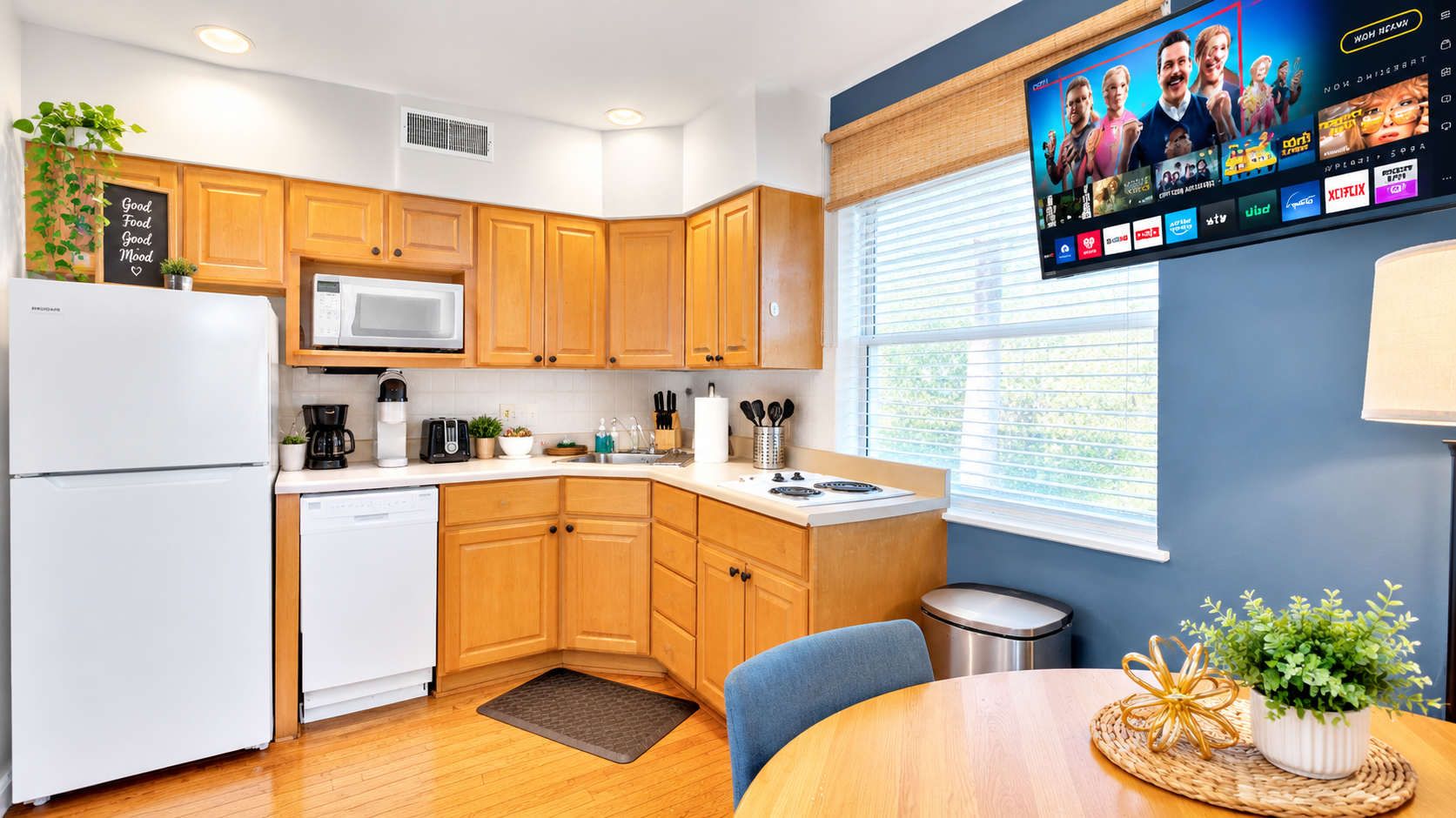 A modern kitchen with wooden cabinets, a microwave, and a coffee maker.