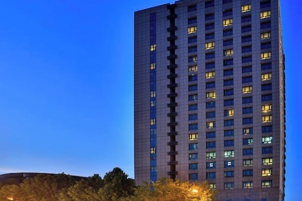 A high-rise building with multiple floors and windows, likely a hotel or office building.