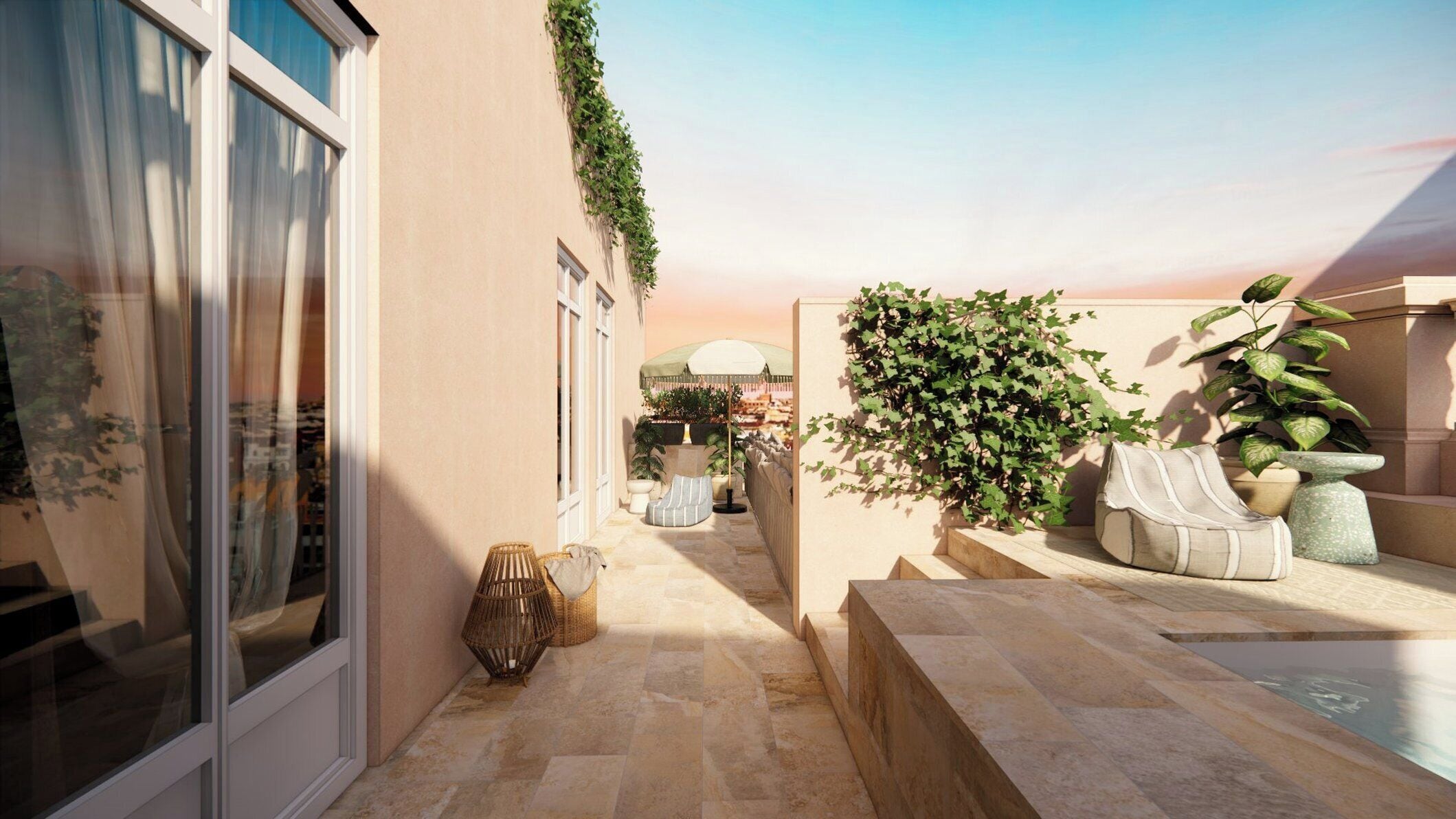 A sunlit courtyard with a stone floor, a seating area, and a view of a cityscape.