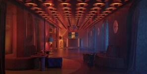 A corridor with a series of circular ceiling lights, a seating area with a table and chairs, and a large mirror on the wall. - Nômade Temple Madrid (Madrid)