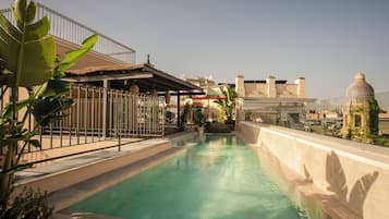 Seasonal outdoor pool, open 10:00 AM to 8:00 PM, pool umbrellas