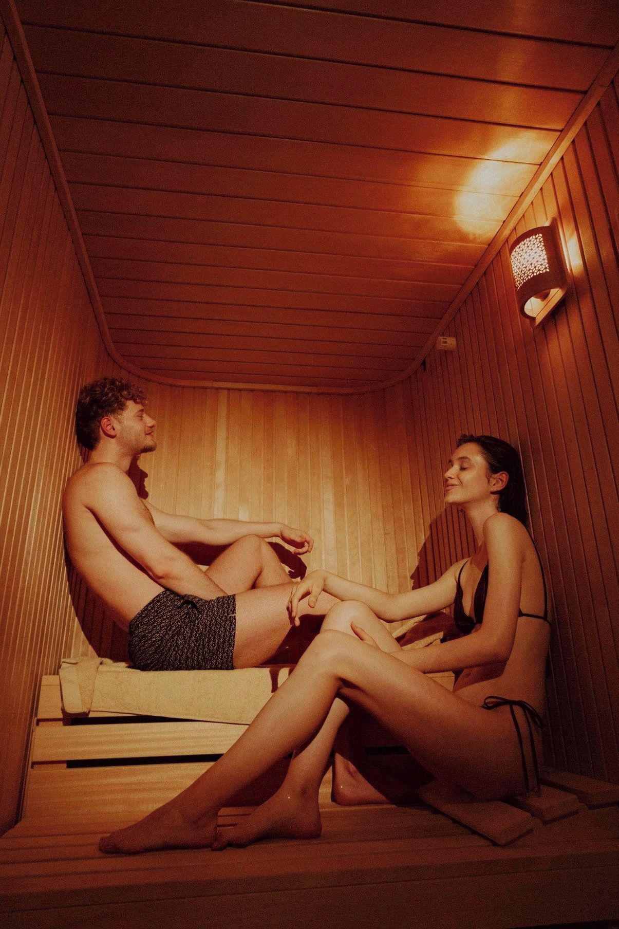 A sauna room with wooden walls and a bench.