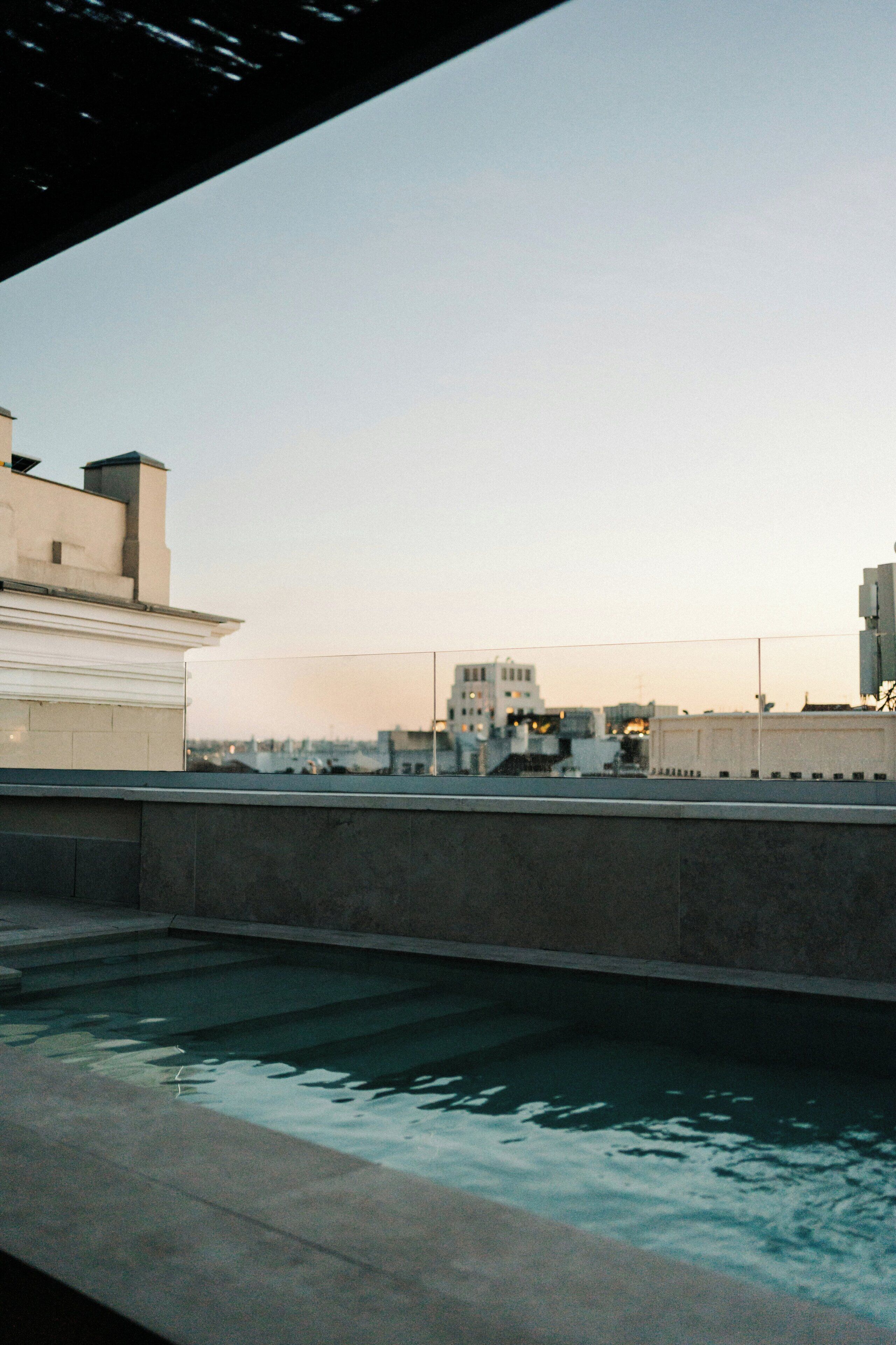 A rooftop pool with a clear view of surrounding buildings.