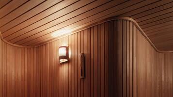 A sauna with wooden benches and a wall-mounted light fixture.