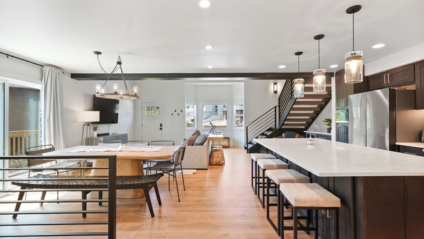 A modern kitchen with a central island, bar stools, and pendant lighting. - New Ski/Summer Home (Cottonwood Heights)