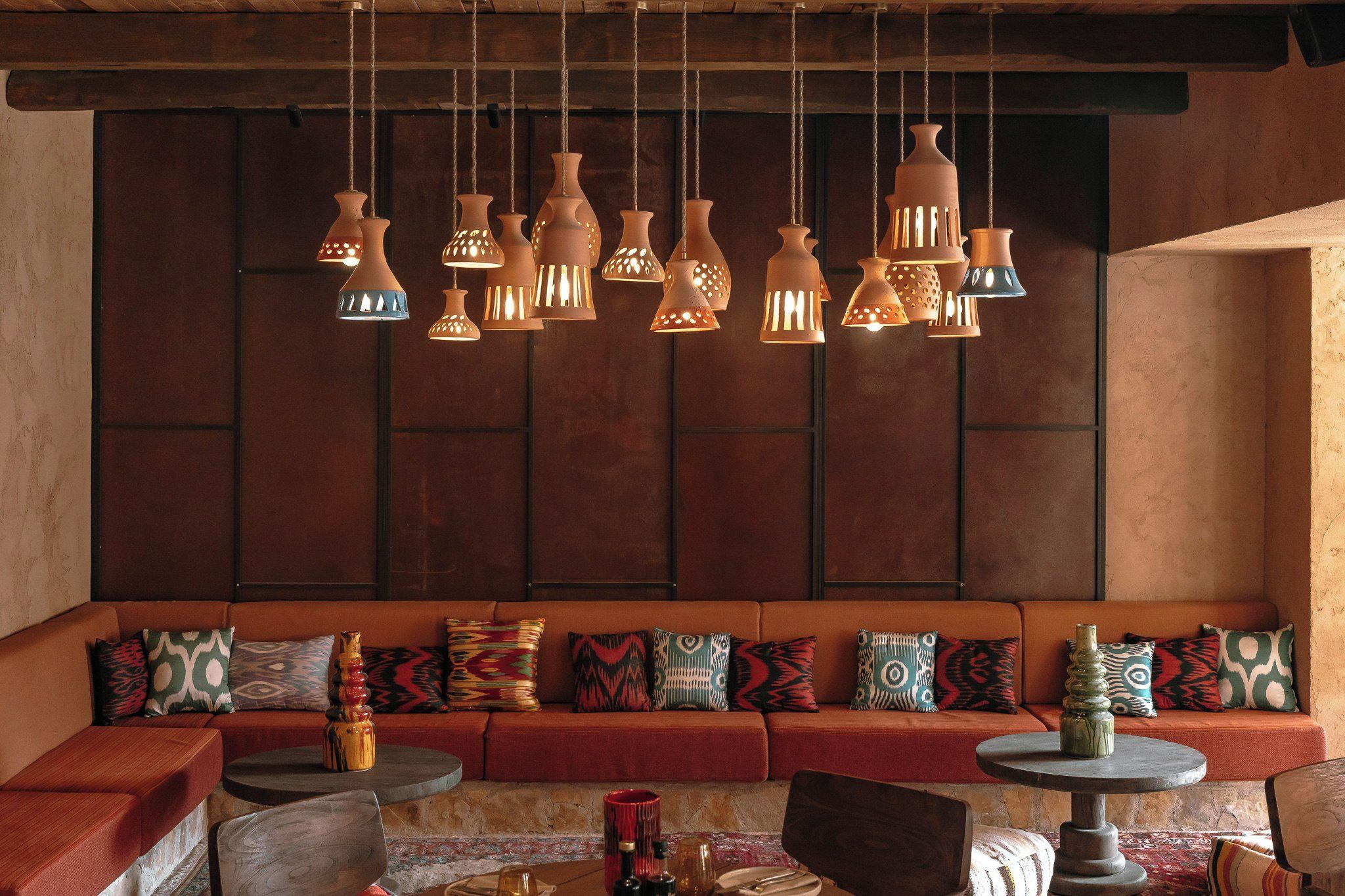 A cozy seating area with a sofa and chairs, a coffee table, and decorative vases.