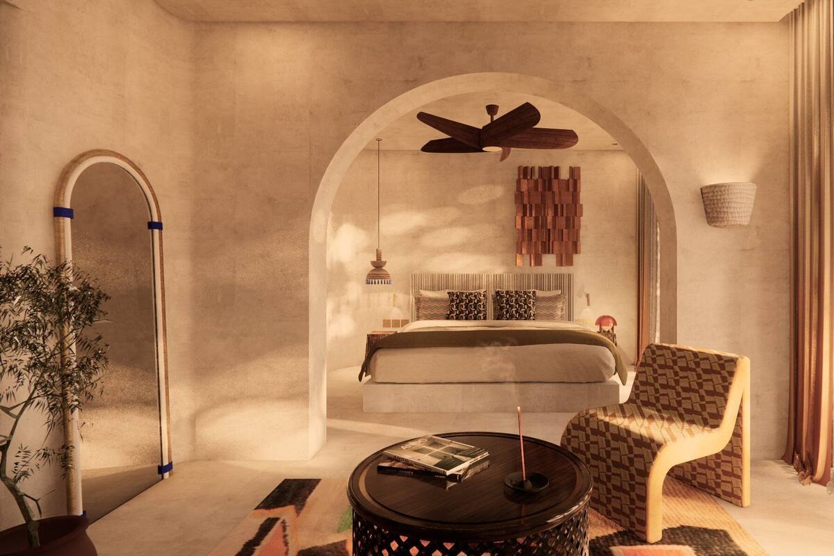 A bedroom with a bed, a ceiling fan, a bedside table, and a chair.