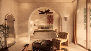 A bedroom with a bed, a ceiling fan, a bedside table, and a chair.