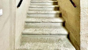 A narrow stone staircase with handrails on both sides, leading upwards. - Le 100% Uzès, Right in the Historic Center (Uzès)