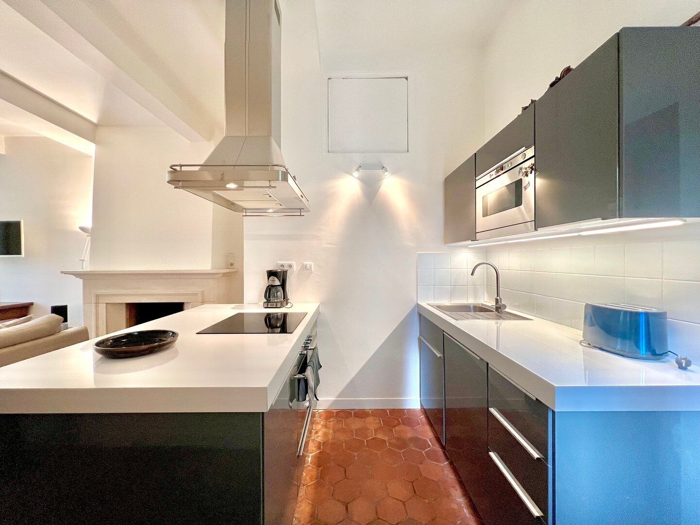 A modern kitchen with a central island, stainless steel appliances, and a sleek design.