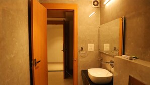 A bathroom with a sink, mirror, and towel rack. - Ananda Castle (Vrindavan)