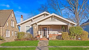 A two-story house with a stone facade, a front porch, and a well-maintained lawn. - Comfortable Apartment - 5 mins from UAB & Hospitals (Birmingham)
