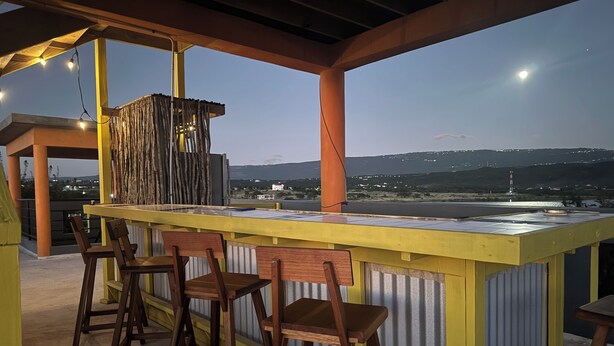 A bar area with a view of the landscape. - The Bakers Villa- Old Wharf Limited (Treasure Beach)