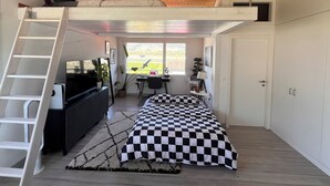 A compact bedroom with a loft bed, a desk, and a window with a view. - STUDIO.LOFT.MOUNTAINS (Collombey-Muraz)