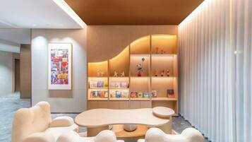 A modern interior with a curved wooden wall, a central round table, and a seating area with chairs.